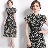 Women's black floral midi dress with sheer fabric and elegant cap sleeves, showcasing a stylish summer design.