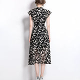Women's black floral midi dress with sheer cap sleeves, featuring an elegant design suitable for summer, highlighting the neckline and waist.