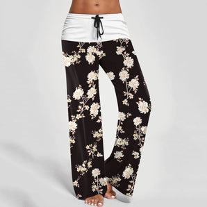 Women's black floral palazzo yoga pants with an adjustable waist and loose fit, shown in size 2XL, featuring a wide leg design and stylish floral pattern.