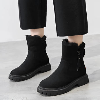 Women's black ankle boots with fur lining, featuring a chunky sole and side zipper, shown in size 42.