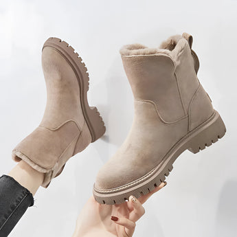 Black fur-lined ankle boots with zipper and chunky sole, featuring a fashion-forward design and durable leather material.