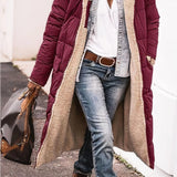 Women's black hooded oversized puffer coat with an urban street style design, featuring a cozy, padded exterior and a relaxed fit, shown in combination with casual jeans and a white dress shirt.