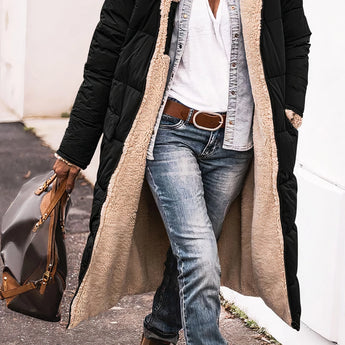 Black oversized puffer coat with a hood, styled for urban street fashion, worn by a woman. The coat is paired with jeans and is in a 3XL size.