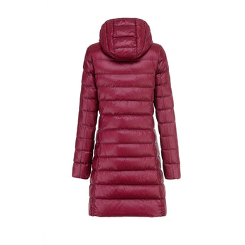 Women's black hooded puffer coat featuring a long quilted design, insulated for warmth, with a fur-trimmed hood, visible collar, and long sleeves.
