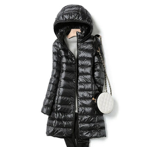 Women's black hooded puffer coat featuring a long quilted design, insulated for warmth. The coat includes a hood, a full-length zipper, and long sleeves.