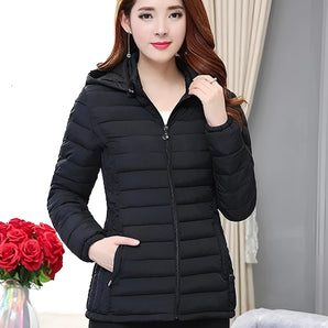 
A woman wearing a black hooded puffer jacket in a slim fit design, showcasing its lightweight feature suitable for winter. The jacket is in a large size, with a visible collar and detailed stitching on the sleeves and waist, emphasizing a tailored look.
