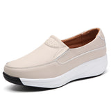 Women's white leather platform loafers showcasing a stylish and comfortable design suitable for walking and outdoor activities.