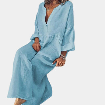 Women's blue wide-leg jumpsuit featuring a v-neckline and long sleeves, designed in a bohemian style with a relaxed fit.