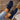 Women's black mesh breathable running sneakers in a slip-on design, shown worn with blu navy denim pants.