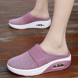 
A pair of women's slip-on sneakers featuring a black mesh upper with pink accents, designed for lightweight comfort, breathability, and quick-drying.