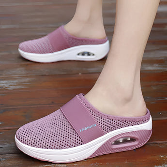 
A pair of women's slip-on sneakers featuring a black mesh upper with pink accents, designed for lightweight comfort, breathability, and quick-drying.