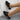 Women's black mesh slip-on sneakers, lightweight and breathable design, shown on a person's feet.