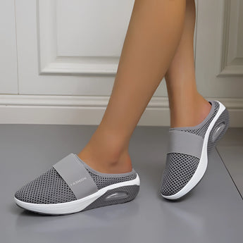 Women's dark gray mesh slip-on sneakers designed for lightweight comfort, breathability, and quick-drying properties, suitable for walking and sports activities.