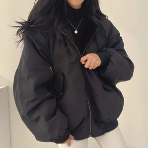 Women's black oversized bomber jacket, trendy puffer winter coat with a high collar, long sleeves, and a relaxed fit.