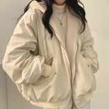 Women's oversized bomber jacket in black, styled as a trendy puffer winter coat. The variant shown is a khaki color in size 2XL, featuring a prominent collar and long sleeves. The design resembles a trench coat with a focus on fashion-forward outerwear.