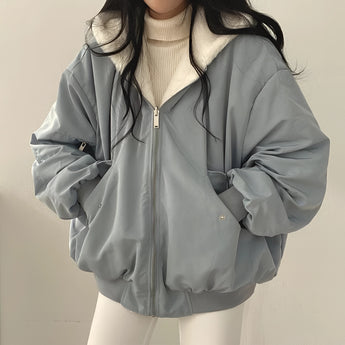 Women's blue oversized bomber jacket in 2XL, featuring a trendy puffer style suitable for winter, with a focus on the outerwear's structured shoulder, neck, sleeve, and collar design.