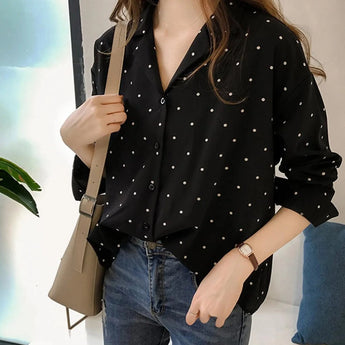 Women's black polka dot blouse in loose fit, featuring long sleeves and a classic round neck, suitable for office wear in size 2XL.