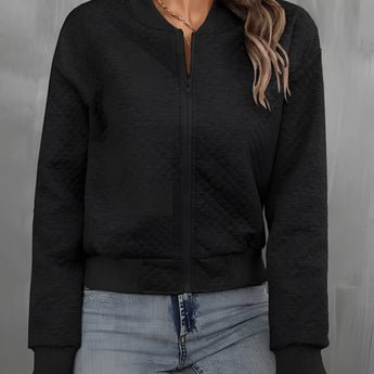 Women's black quilted bomber jacket featuring lightweight fabric and trendy design, ideal for fall layering.