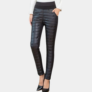 Women's black quilted thermal skinny pants showcasing a fitted design ideal for winter fashion, highlighting the waist, thigh, and knee areas.
