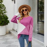 Women's black ribbed color block sweater featuring white cuffs, styled casually. The sweater is worn with fashionable sunglasses and a hat, showcasing the outfit's trendy and laid-back look.