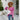 Women's black ribbed color block sweater featuring white cuffs, styled casually. The sweater is worn with fashionable sunglasses and a hat, showcasing the outfit's trendy and laid-back look.