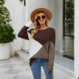 Women's black ribbed color block sweater featuring white cuffs, shown in brown color and XL size. The sweater has a casual knitwear style, with a focus on the shoulder and sleeve design. Fashion accessories like a hat and sunglasses are also visible.