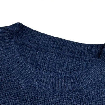 Women's black ribbed color block sweater with white cuffs featuring a cozy knit design, long sleeves, and a stylish pattern suitable for casual wear.