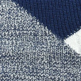 Women's black ribbed color block sweater with white cuffs, showcasing a casual knitwear design with long sleeves and a distinct pattern.