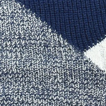 Women's black ribbed color block sweater with white cuffs, showcasing a casual knitwear design with long sleeves and a distinct pattern.