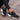 Women's black running sneakers featuring breathable mesh and a cushioned sole, shown in the color Nero and size 42, placed on a grey flooring surface.