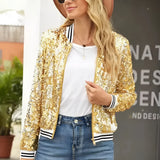 
A women's black sequin bomber jacket with a shiny glitter finish and zip-up closure, displayed in a gold color, size 2XL. The jacket features long sleeves and a comfortable fit.