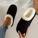 Women's black shearling fuzzy lined platform loafers on a person's feet, showcasing the comfortable and cozy design with thick soles.