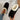 Women's black shearling fuzzy lined platform loafers on a person's feet, showcasing the comfortable and cozy design with thick soles.