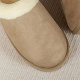 Women's black shearling fuzzy lined platform loafers with a beige wool lining, combining fashion and comfort with leather and woven fabric elements.