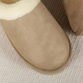 Women's black shearling fuzzy lined platform loafers with a beige wool lining, combining fashion and comfort with leather and woven fabric elements.