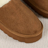 Women's black shearling fuzzy lined platform loafers with a textured leather exterior, showcasing a cozy and comfortable design.