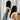 Women's black shearling fuzzy lined platform loafers on a model's feet, showcasing the footwear's stylish design and cozy lining against a neutral background.