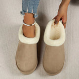 Women's black shearling fuzzy lined platform loafers being worn, showcasing the footwear's plush lining and stylish design.