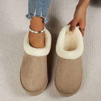 Women's black shearling fuzzy lined platform loafers being worn, showcasing the footwear's plush lining and stylish design.