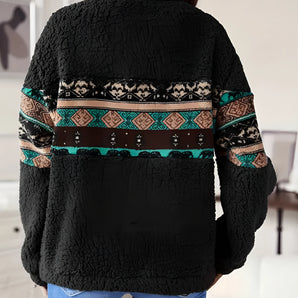 Women's black sherpa fleece jacket with a tribal pattern, featuring long sleeves and a high neck, shown on a standing model.