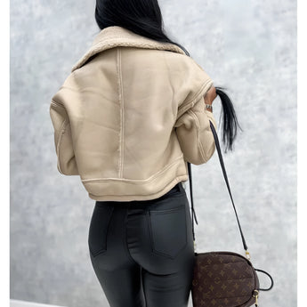 Women's black sherpa-lined biker jacket featuring a faux fur collar, shown with long sleeves and extending to the waist, highlighting the collar and outerwear style.