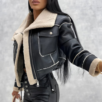 Women's black biker jacket featuring a sherpa-lined interior and a faux fur collar, shown in size large. The jacket has a classic biker design with long sleeves, tailored waist, and extends to the thigh. The outer material is predominantly black with contrasting textures.