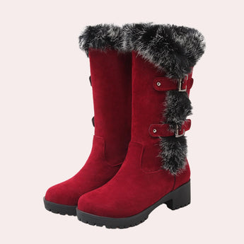 Women's red knee-high winter boots in suede with fur trim, featuring a sleek design suitable for cold weather fashion.
