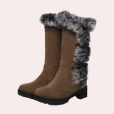 Women's brown suede knee-high winter boots with fur trim, featuring a natural leather material and a sturdy design suitable for snowy conditions.