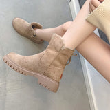 Women's black suede waterproof fur-lined winter ankle boots worn by a person, showcasing comfort and style against a neutral background.