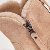 Women's black suede waterproof fur-lined winter ankle boots on a neutral background.