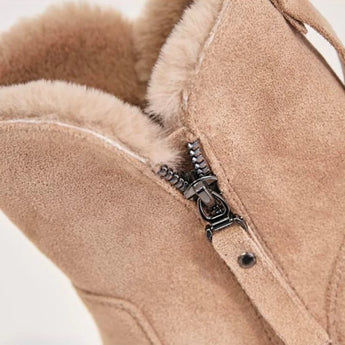Women's black suede waterproof fur-lined winter ankle boots on a neutral background.
