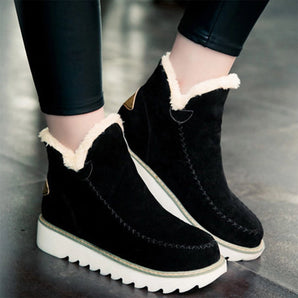 Women's black suede wedge winter boots with fleece lining, featuring a non-slip sole, shown on a person standing.