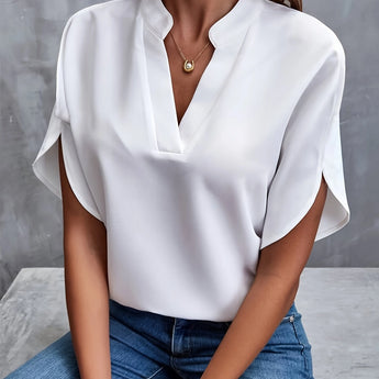 Women's black V-neck blouse with split sleeves, styled for an elegant summer work look.