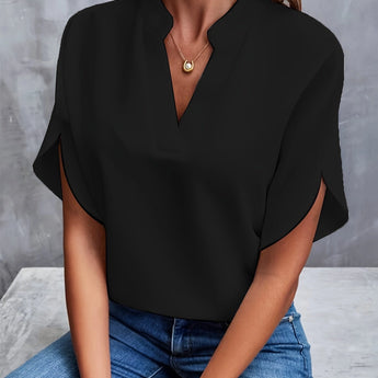 Women's black V-neck split sleeve blouse worn by a model, paired with jeans. The blouse is elegant and suitable for summer workwear, highlighting the shoulders and featuring a fashionable design.